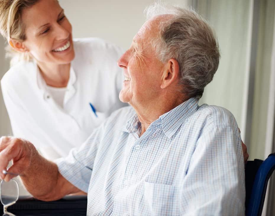 About_Promise_3_930x730 Older Gentleman Patient in Wheelchair Laughing with Female Doctor