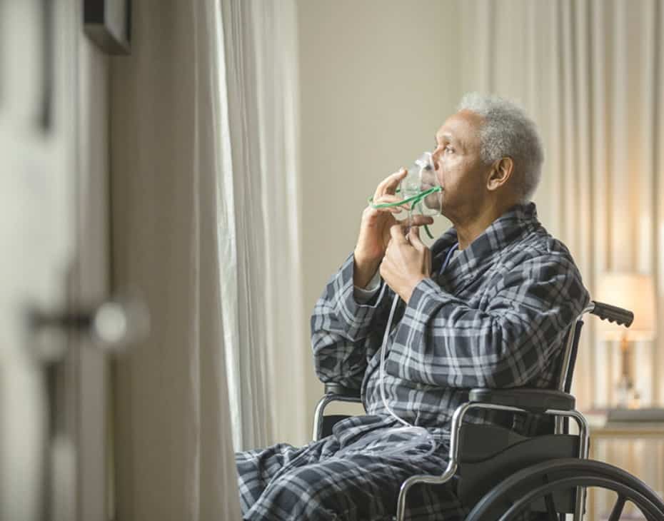 COPD Elderly Man Adjusts an Oxygen Mask on His Face