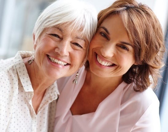 Two women hugging and happy