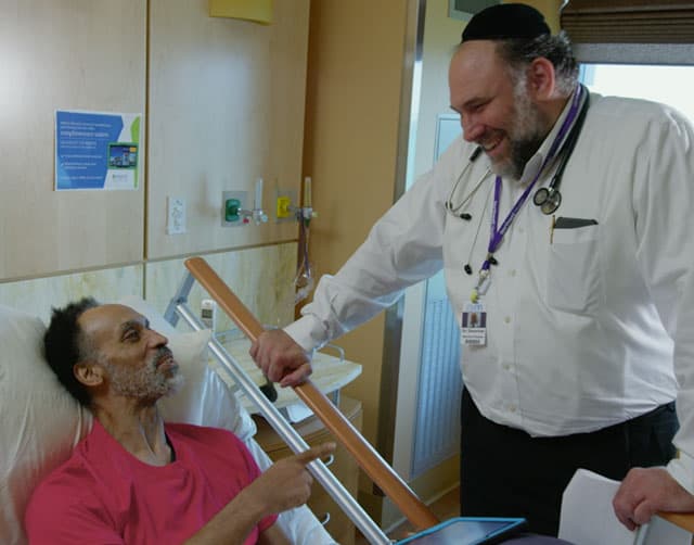 hospice_2 Patient Smiles and Laughs with Doctor