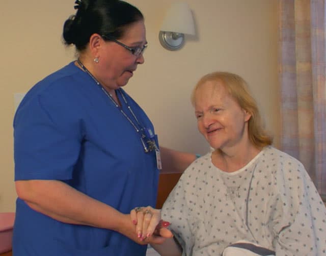 hospice_levels MJHS Caregiver Holds the Hand of Elderly Patient