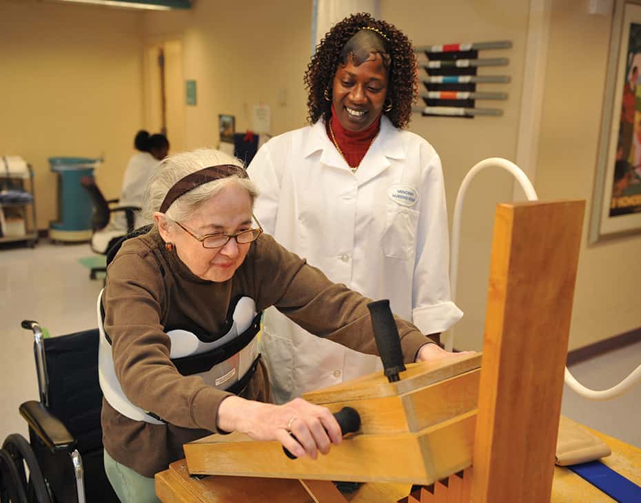 Therapist Helping Senior Patient Exercise for Physical Rehabilitation