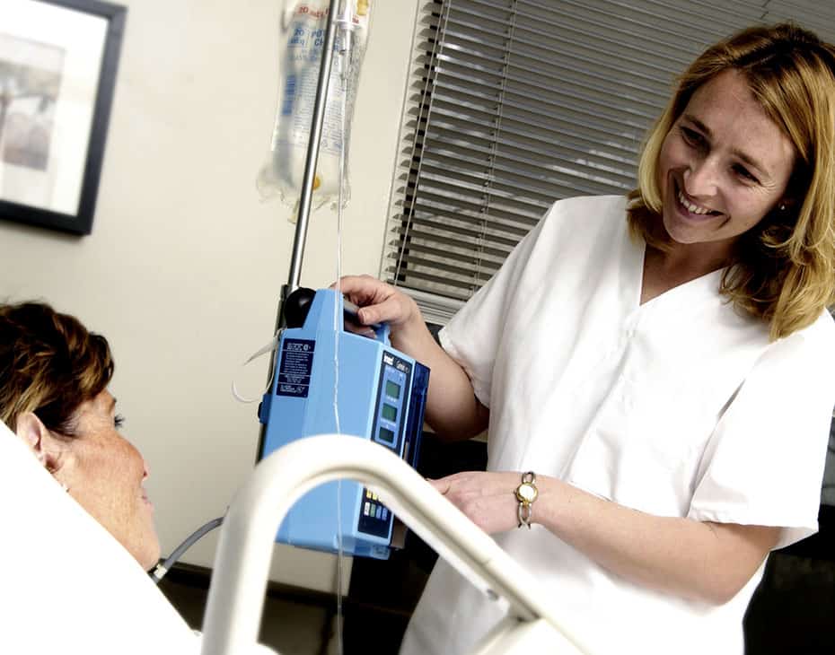 Nurse with IV drip machine