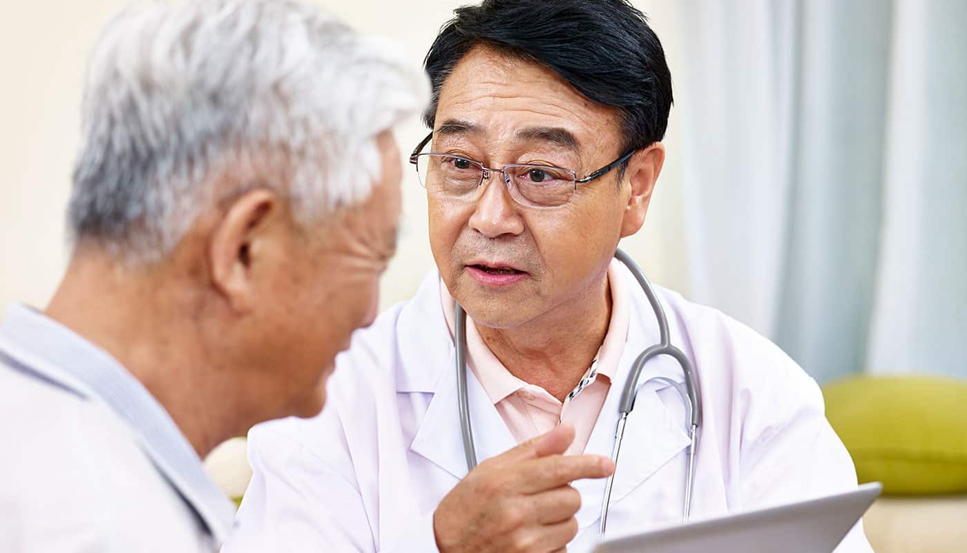 summary Doctor Reviews a Clipboard with Patient