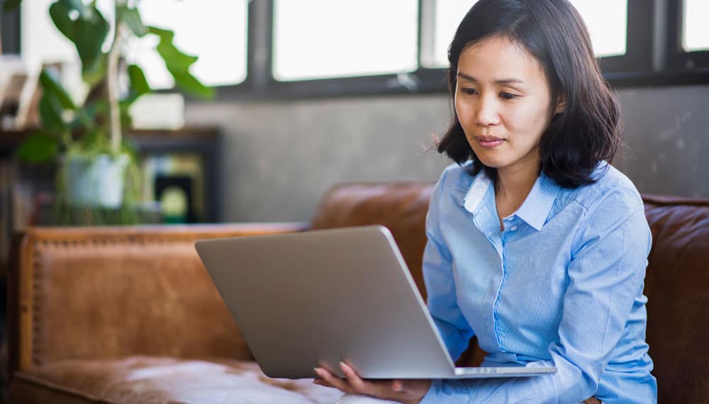 Woman Using Laptop Searching for Caregiver Resources Woman Using Laptop Searching for Caregiver Resources