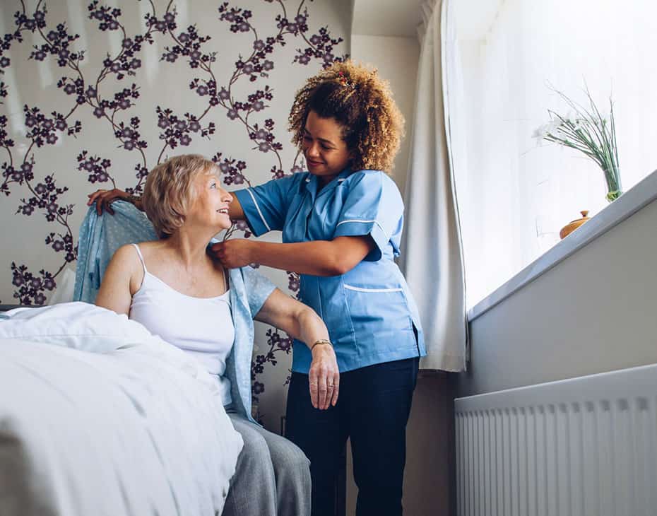 home_health_aides MJHS Nurse Assists Elderly Female Getting Dressed