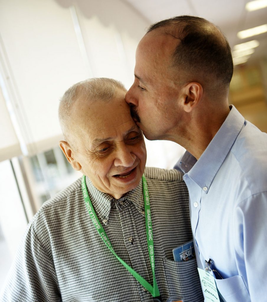 Family Member Kisses a Loved One on the Forehead