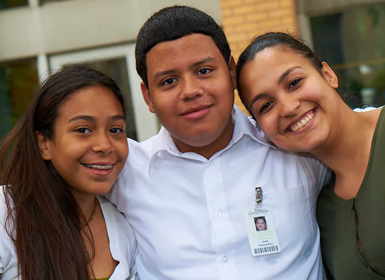 volunteer MJHS Volunteer Smiles with Two Younger Females