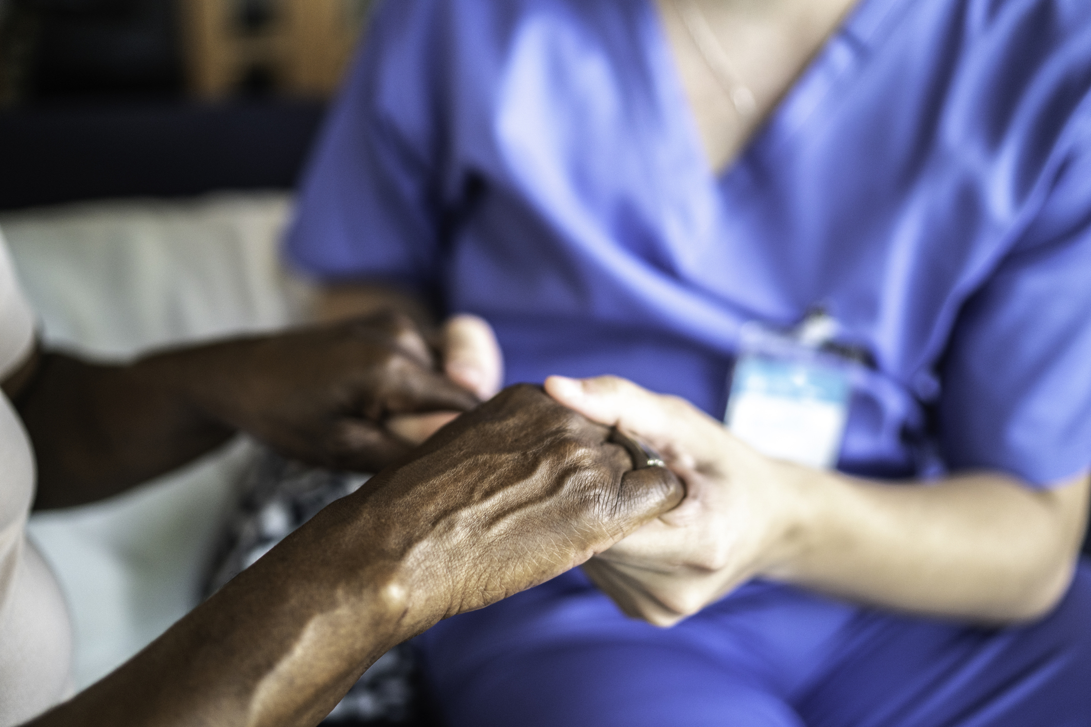 Caregiver and Patient Holding Hands
