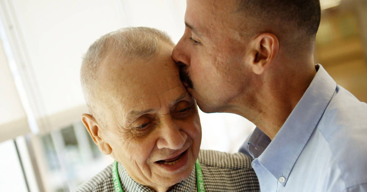 Man Kissing Father's Head
