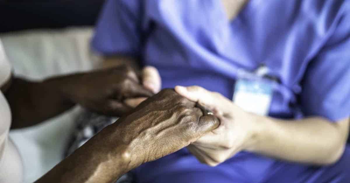 Caregiver and Patient Holding Hands