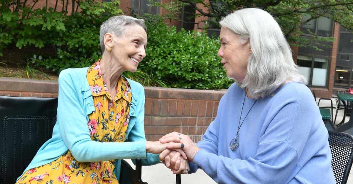 Dos mujeres mayores consolándose entre sí