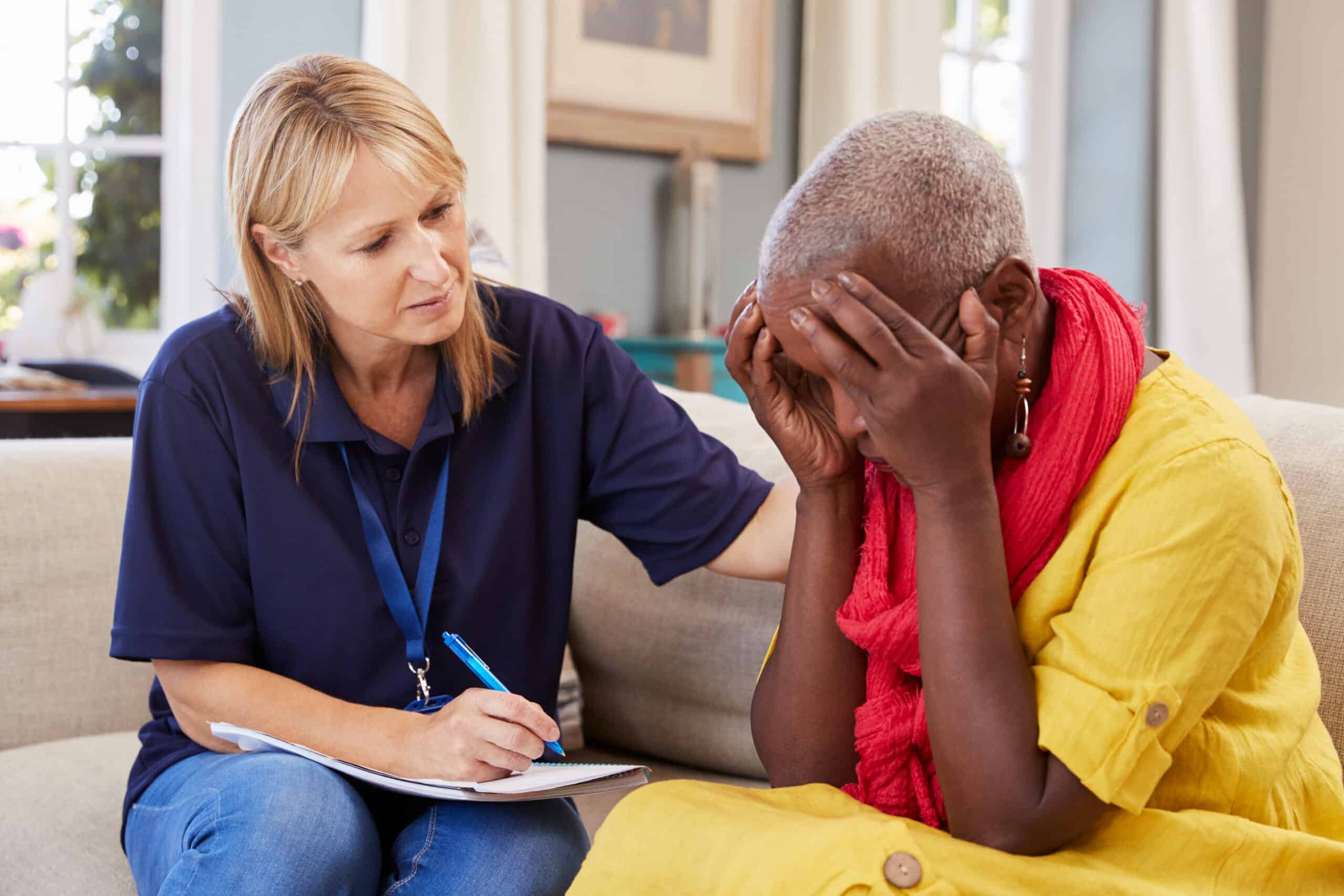 female presenting social worker consoling and caring for someone who is upset.